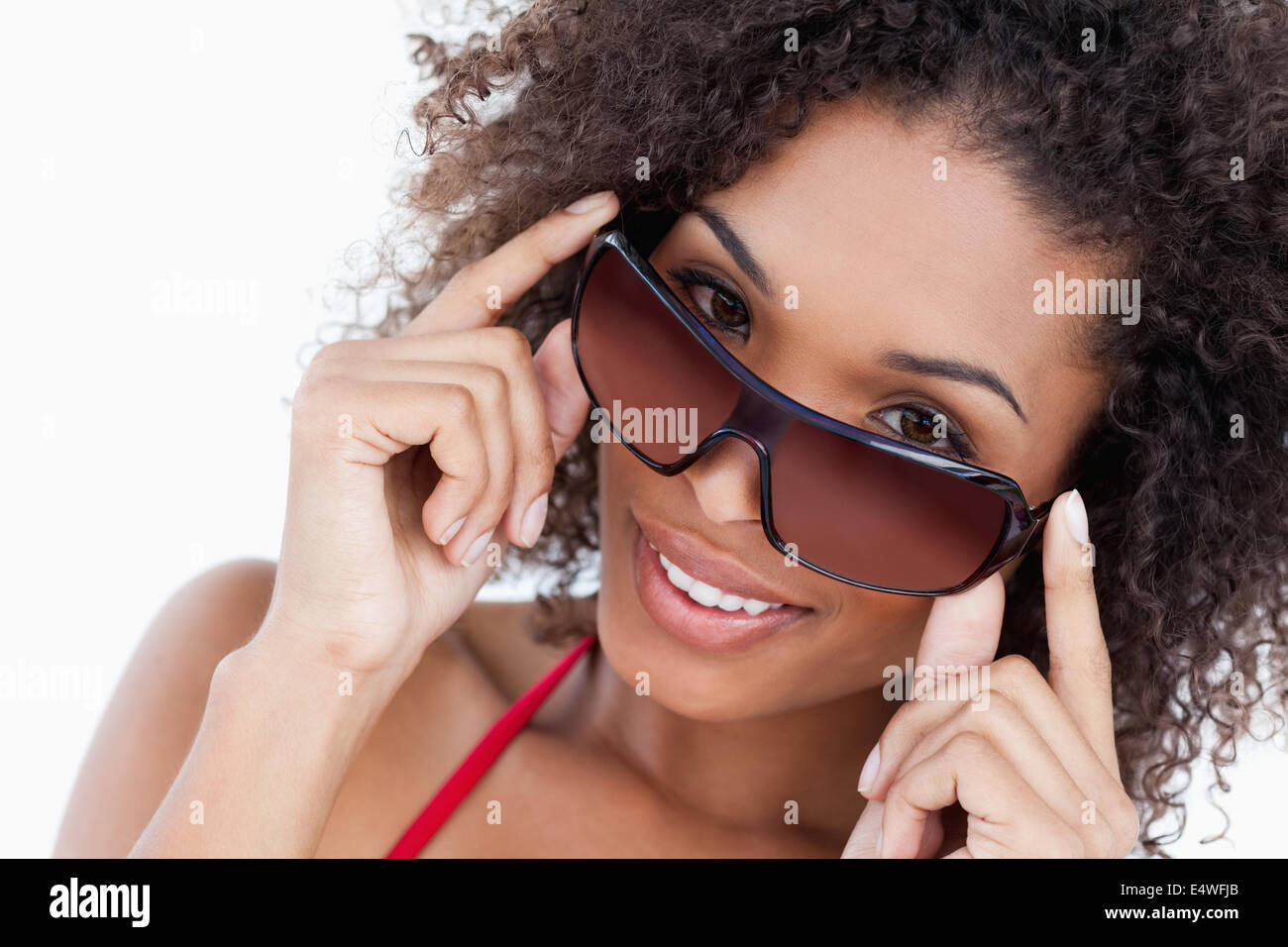 Smiling woman looking aver her sunglasses Stock Photo