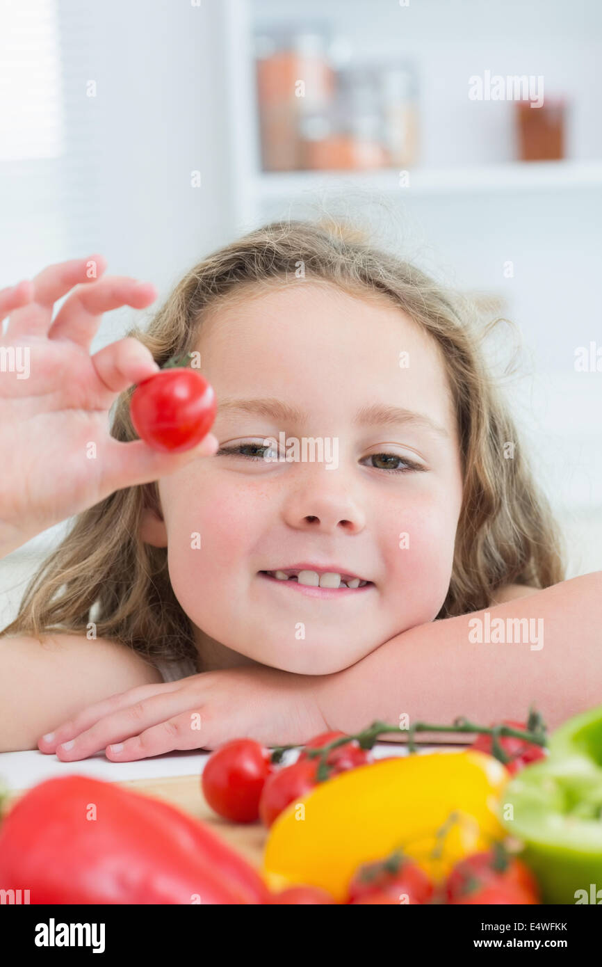 Girl holding cherry tomato Stock Photo - Alamy