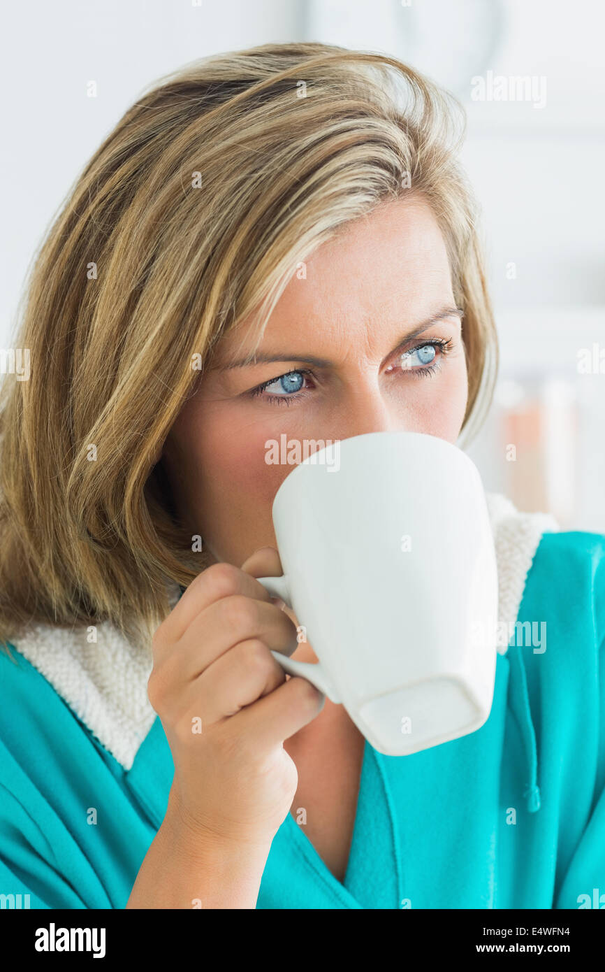 Woman in bathrobe drinking coffee Stock Photo Alamy
