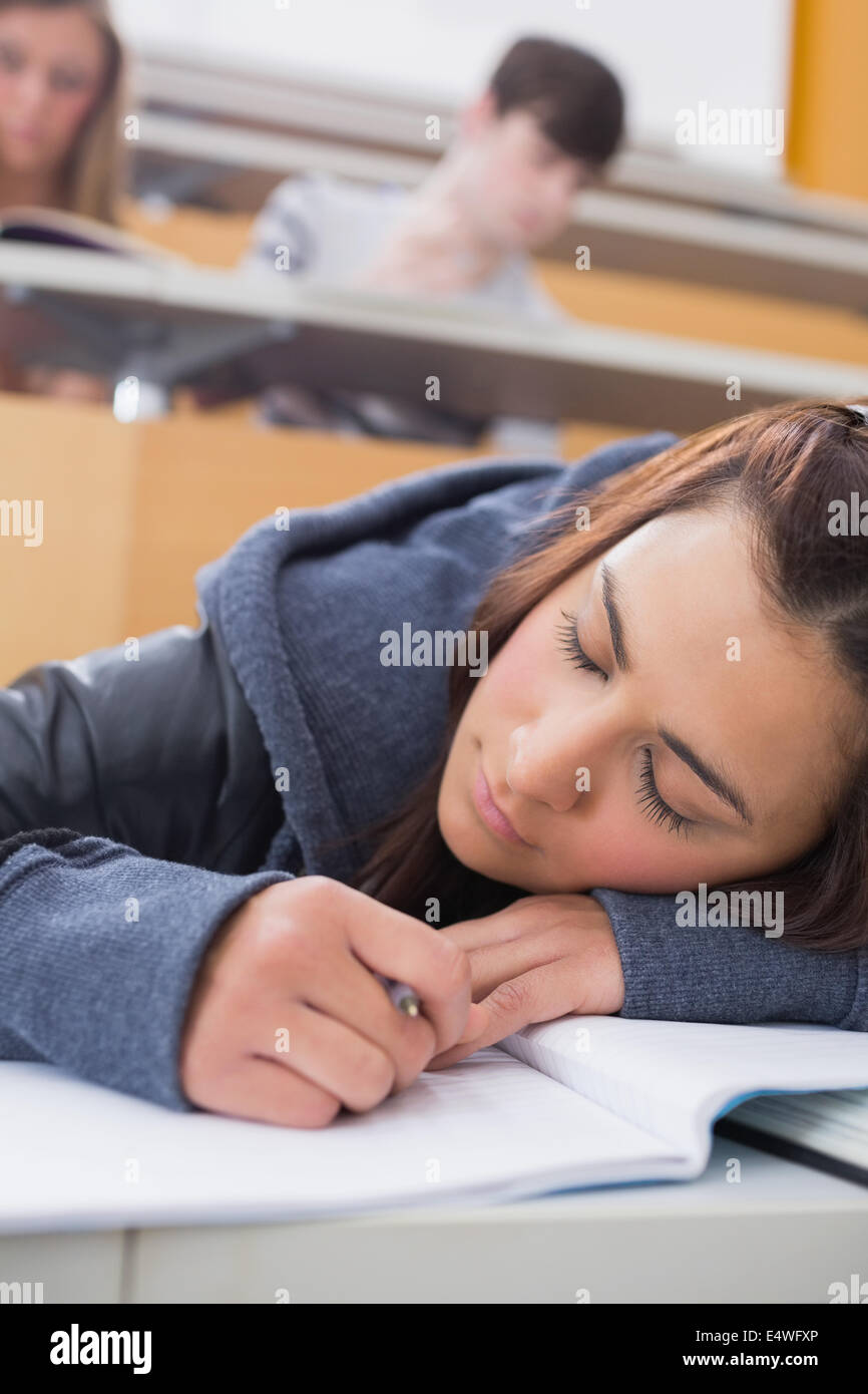 Woman leaning at the desk sleeping Stock Photo