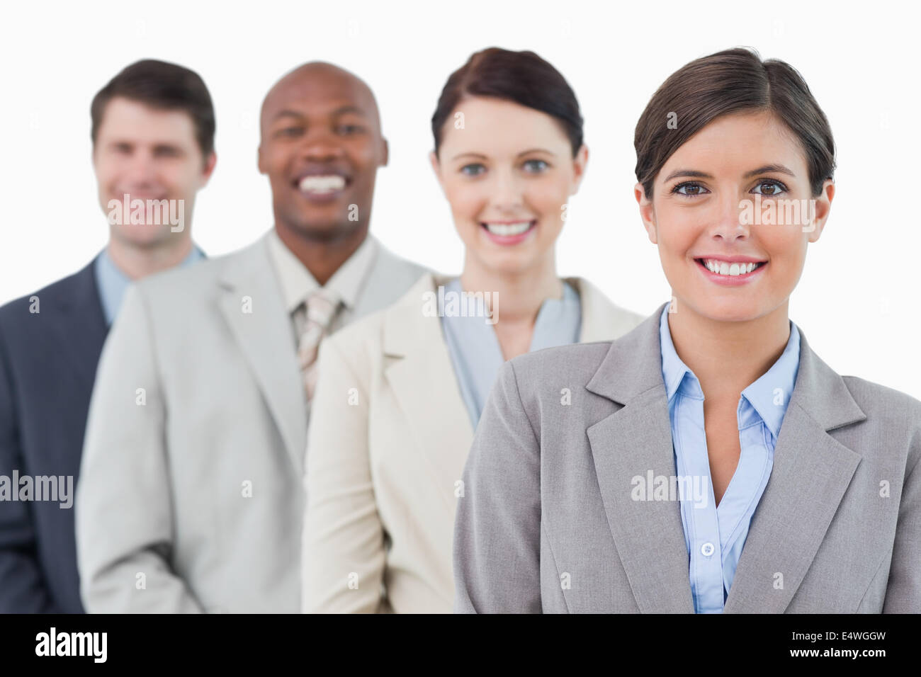 Smiling young businessteam standing Stock Photo - Alamy