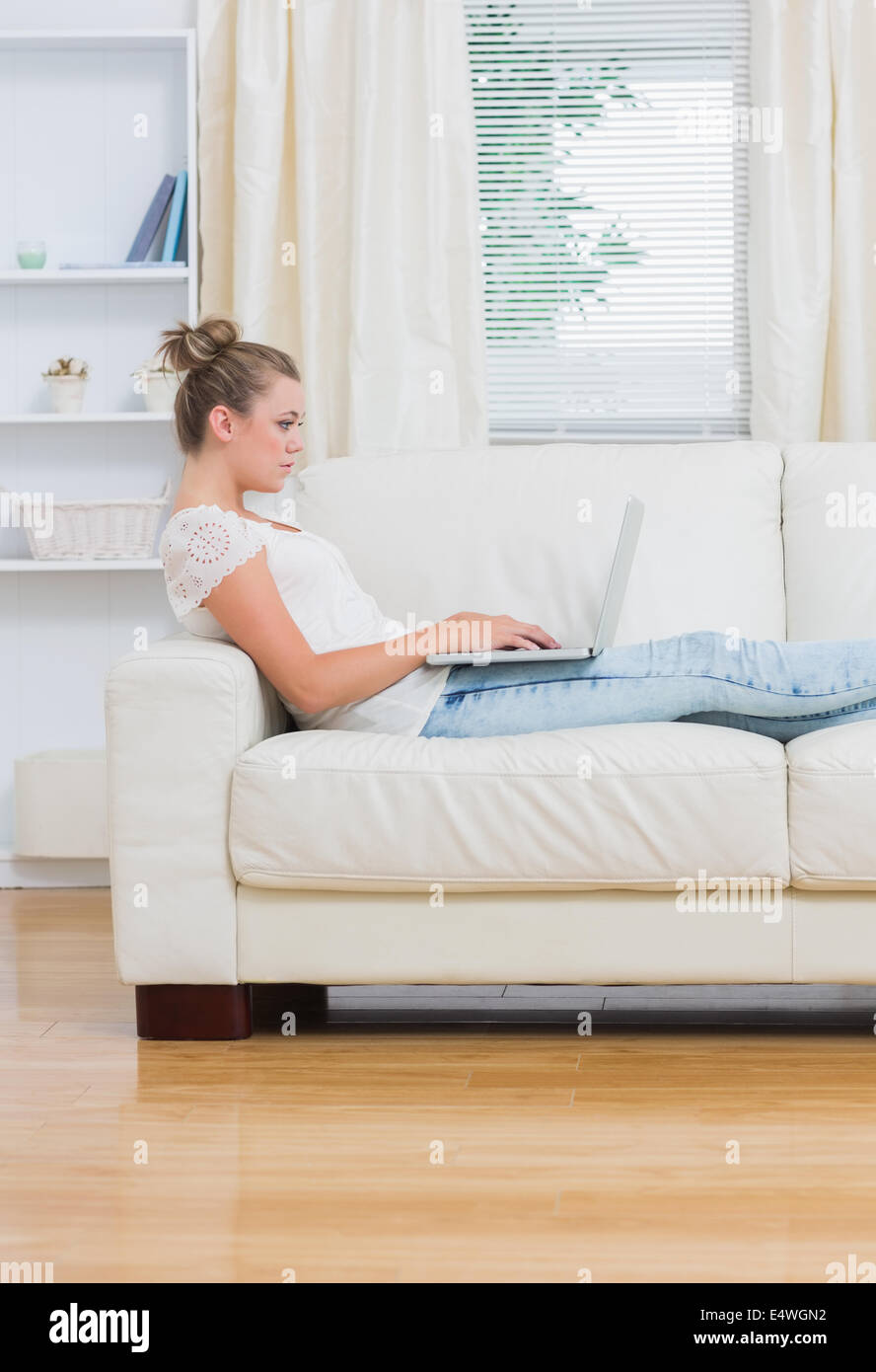 Woman working on laptop in the living room Stock Photo - Alamy