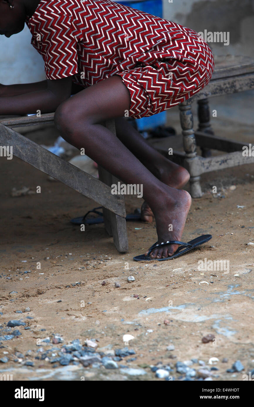 Closeup of an african girl sitting on a chair outside Stock Photo