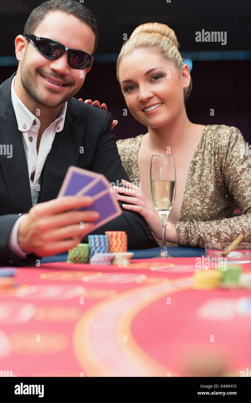Couple sitting at the poker table smiling Stock Photo