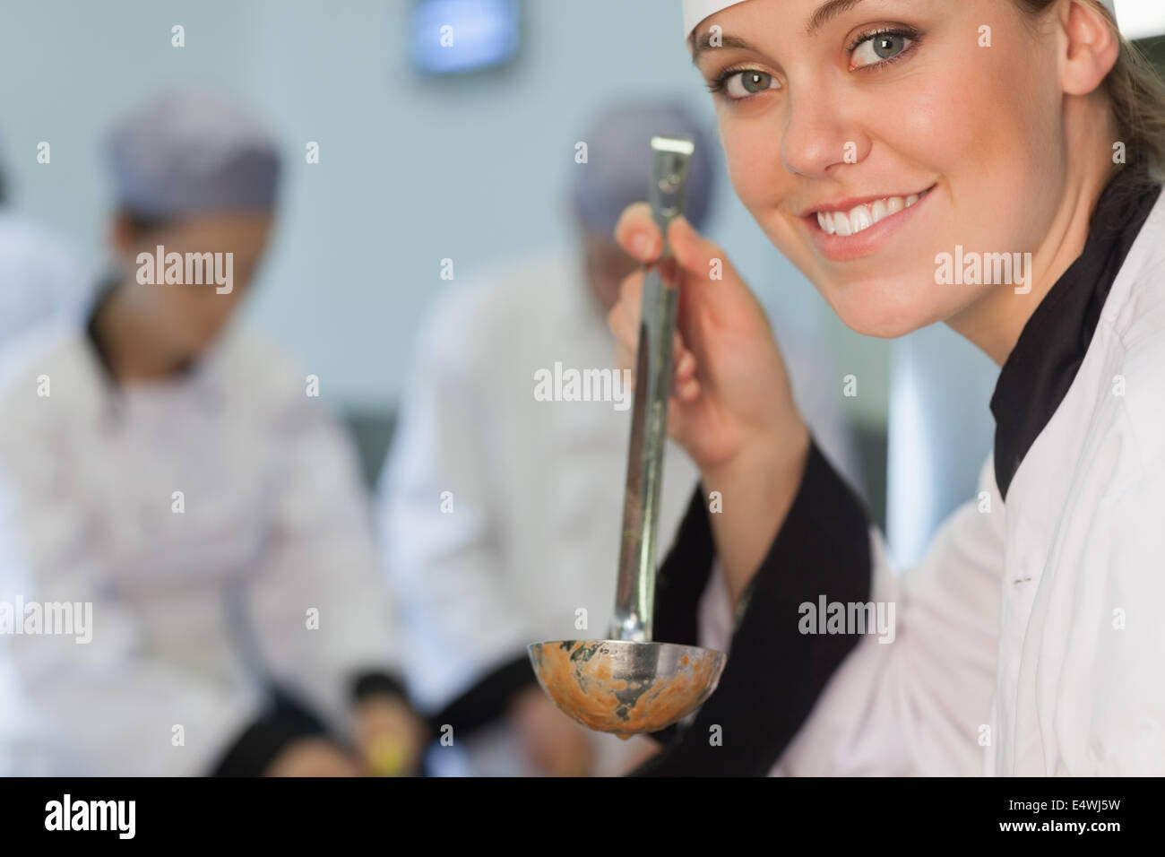 Happy chef about to taste soup Stock Photo