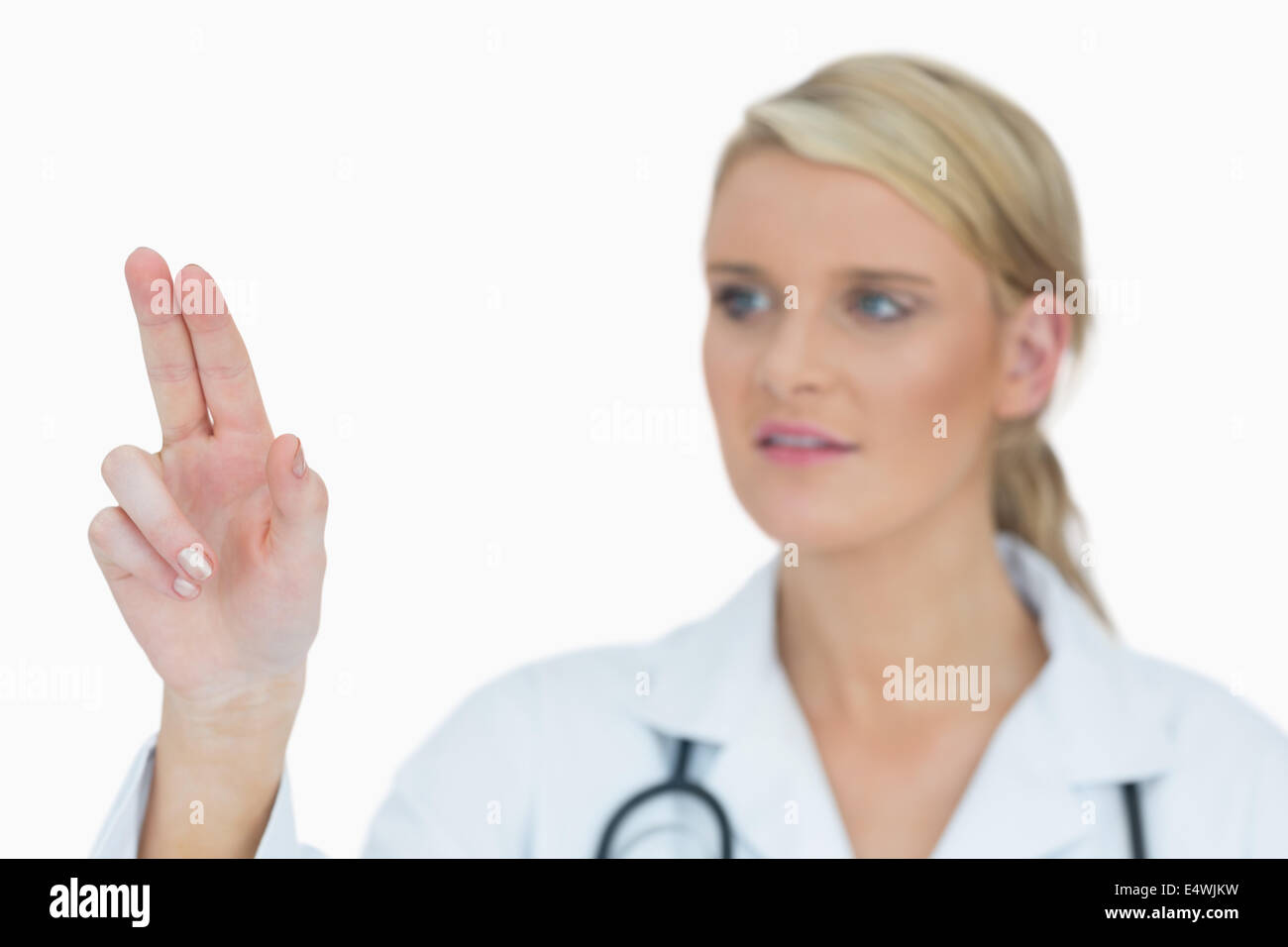 young-doctor-pointing-a-promotion-with-his-finger-handsome-doctor-pointing-at-advertising-space