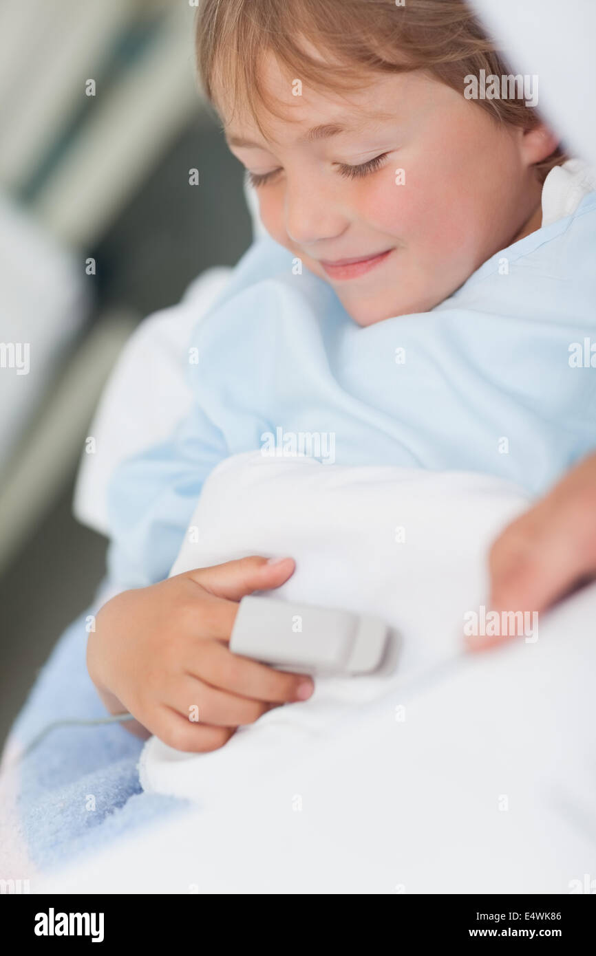 Smiling child lying on a medical bed Stock Photo