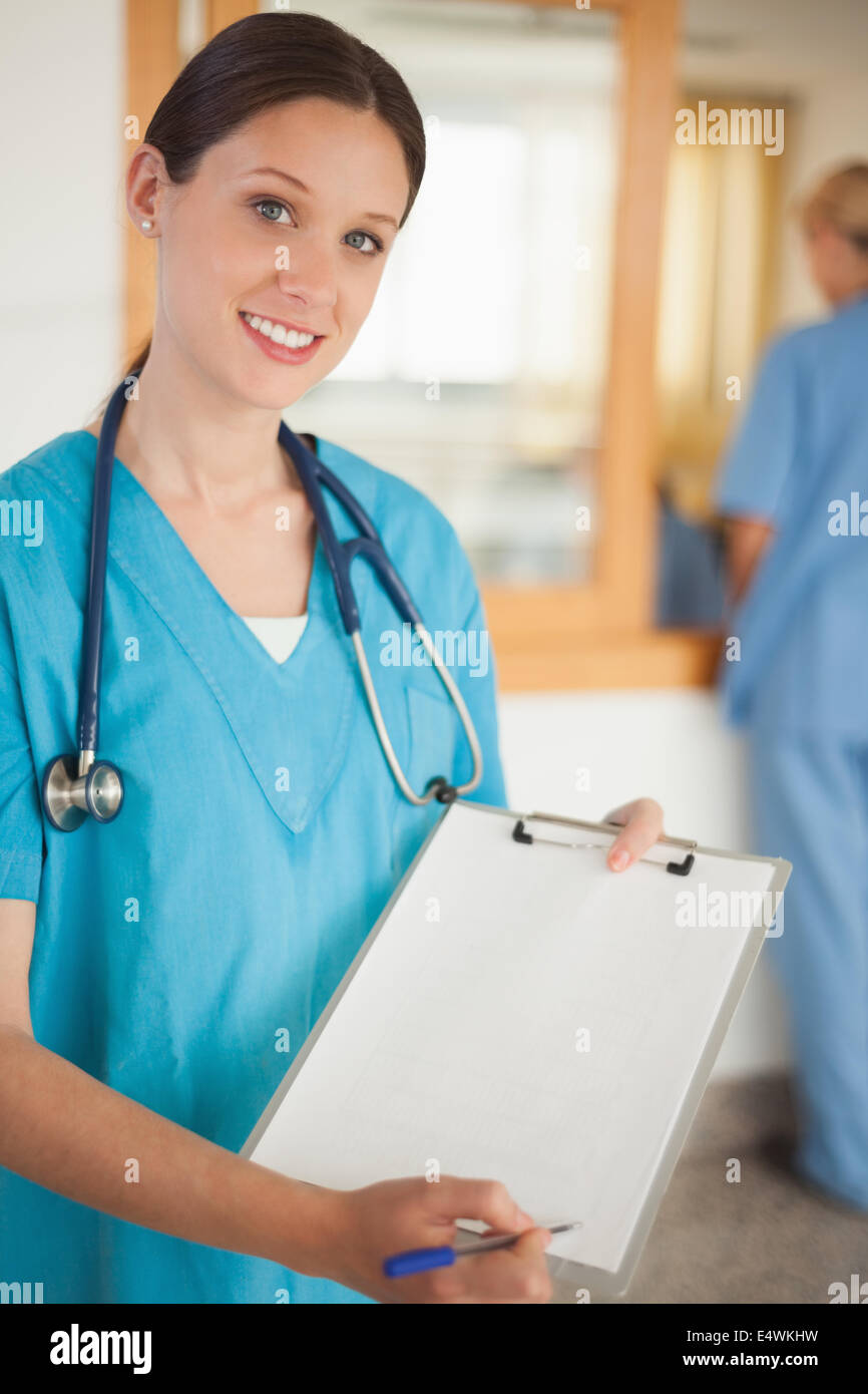 Female intern showing a clipboard Stock Photo