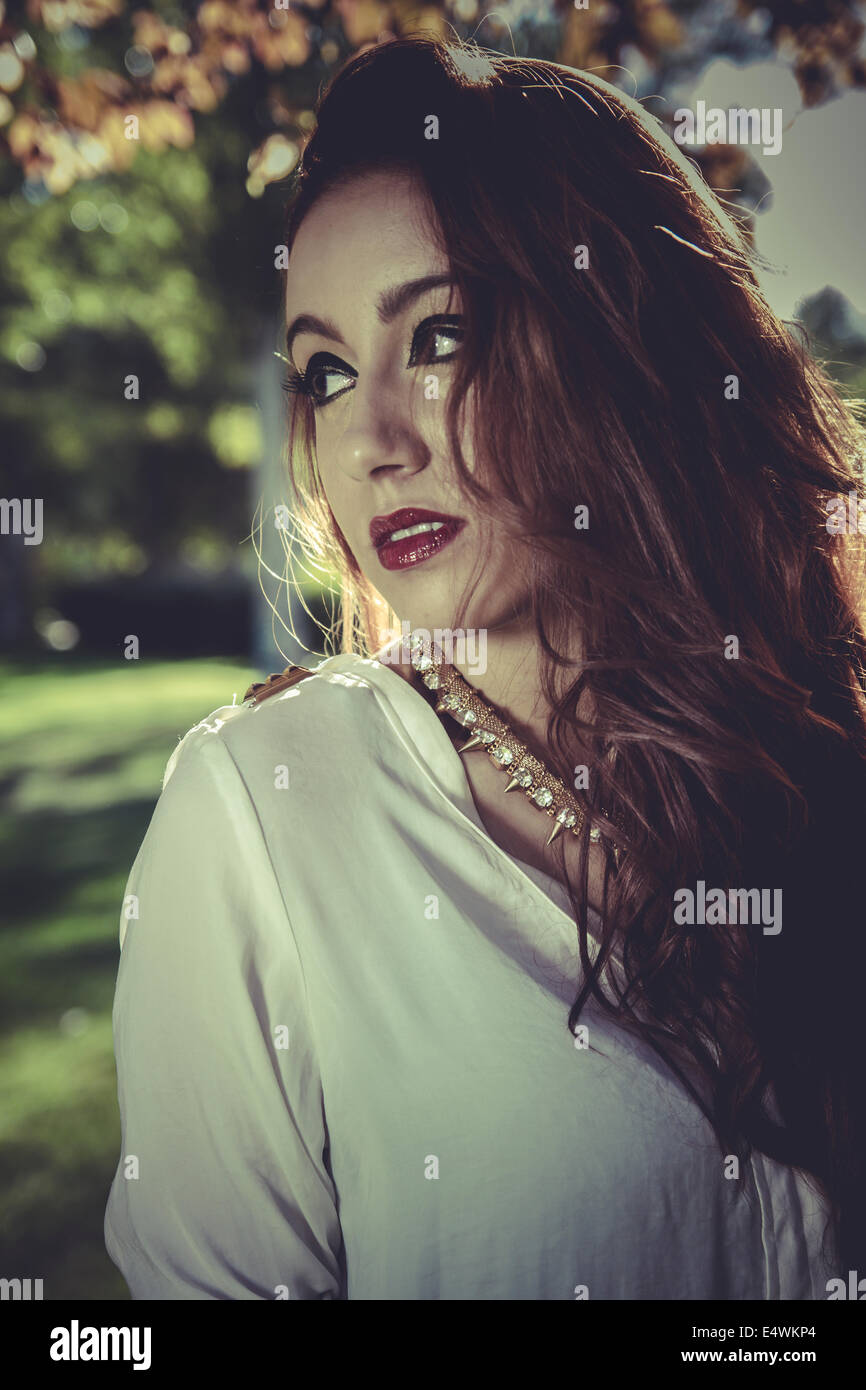 portrait redhead girl with white shirt in a park with trees Stock Photo ...