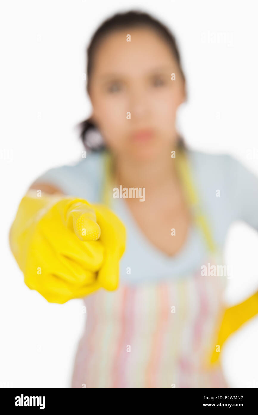 Woman in apron pointing accusingly Stock Photo