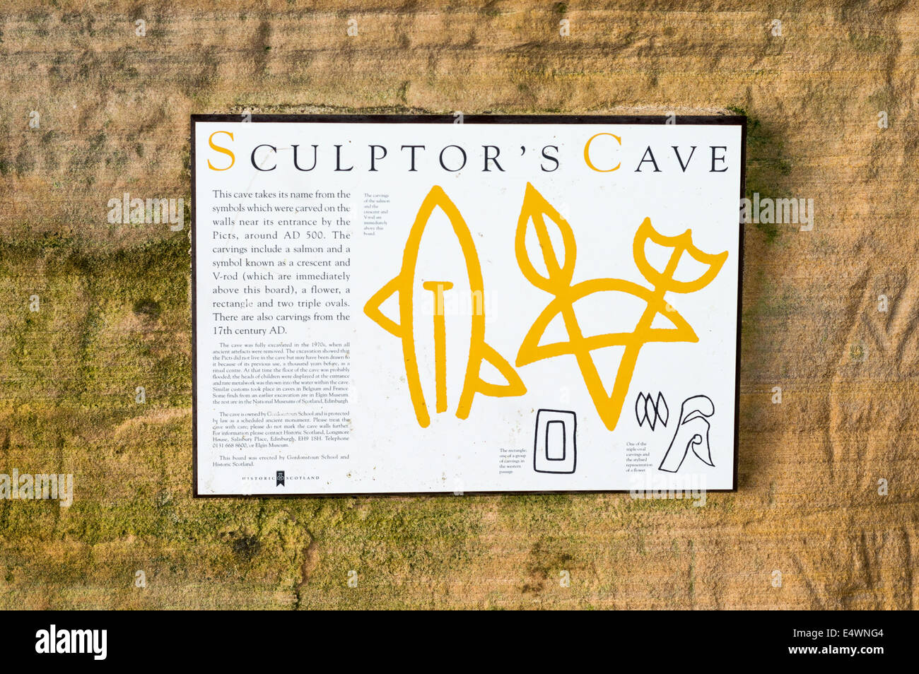 EXPLANATORY SIGN IN SCULPTORS CAVE NEAR HOPEMAN MORAY COAST SCOTLAND SHOWING THE PICTISH SYMBOLS CARVED INTO THE SANDSTONE WALLS Stock Photo