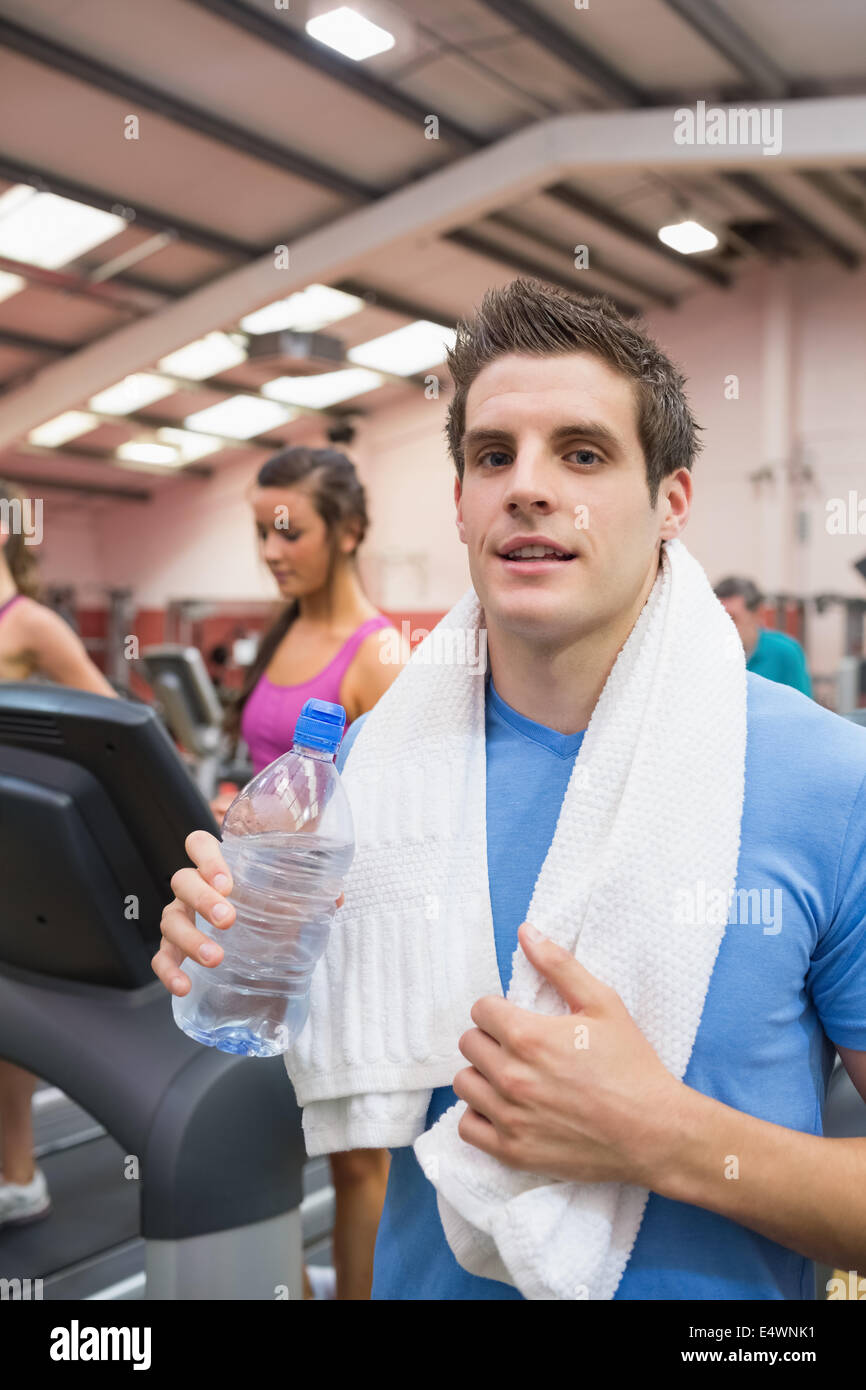 Man smiling and drinking water in gym Stock Photo - Alamy