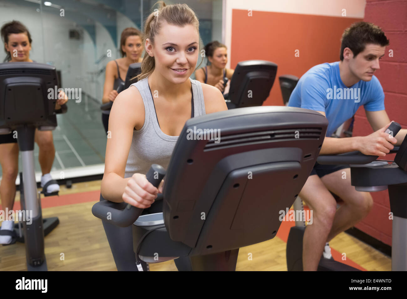Smiling woman in spin class Stock Photo - Alamy