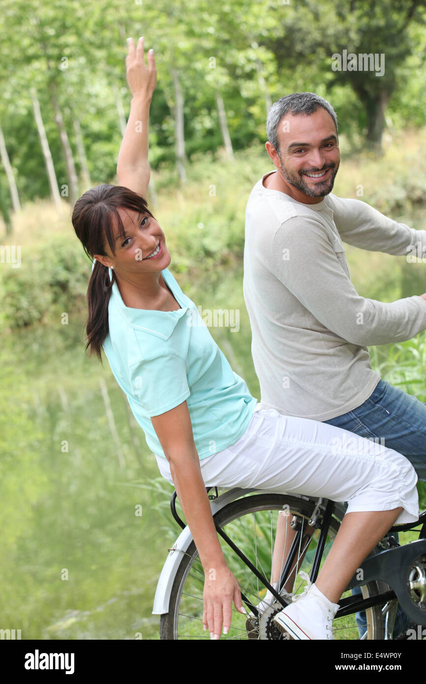 a couple doing bike in the country Stock Photo
