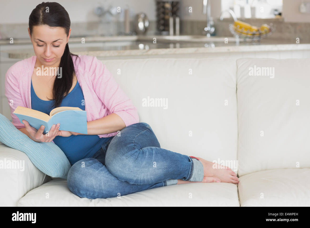 Young woman relaxing while reading a book Stock Photo - Alamy