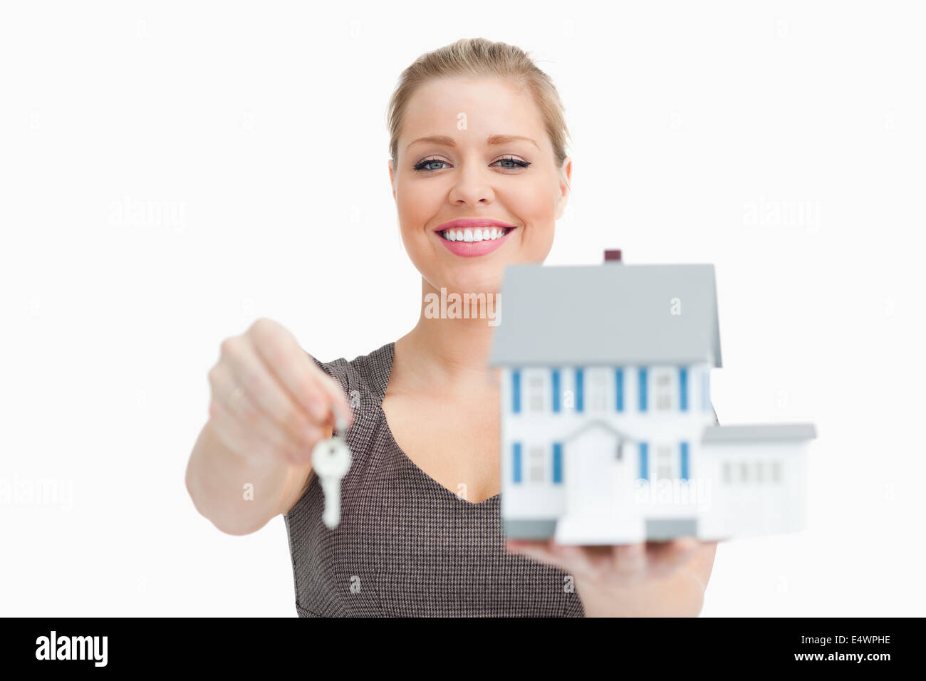 Model house and a key holding by a woman Stock Photo - Alamy