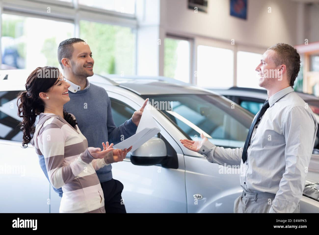 Couple chatting with a salesman Stock Photo