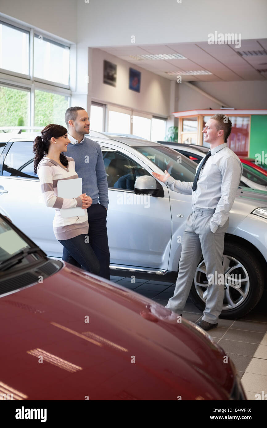 Salesman talking with a couple Stock Photo