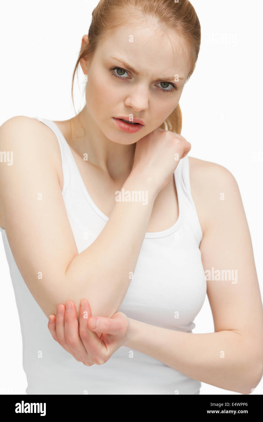 Blonde woman touching her elbow Stock Photo Alamy