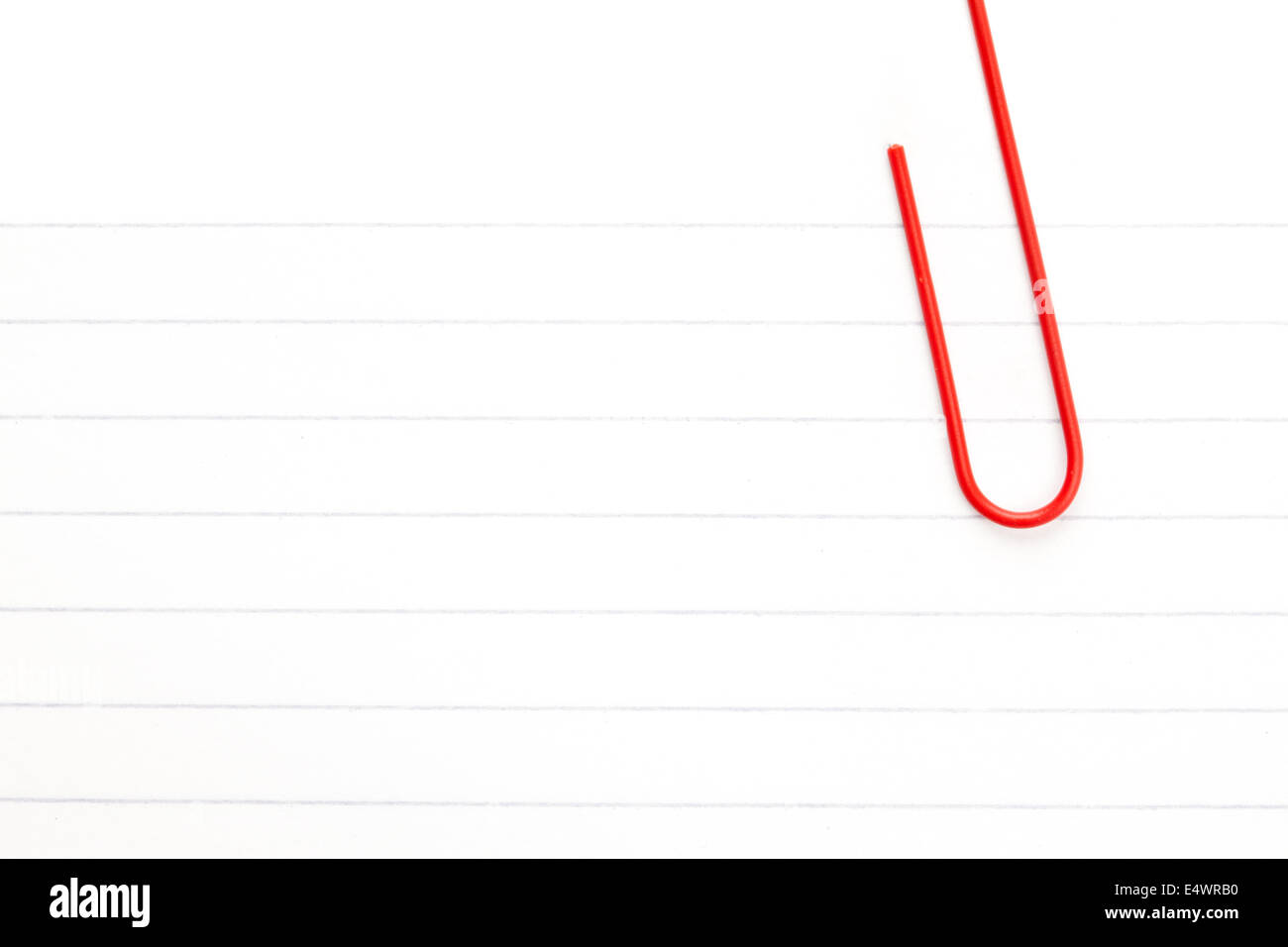White paper with a red paperclip Stock Photo