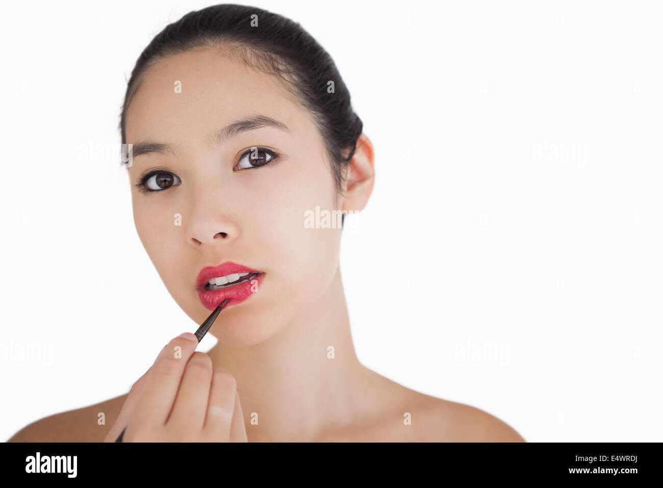 Woman putting on lipstick Stock Photo - Alamy