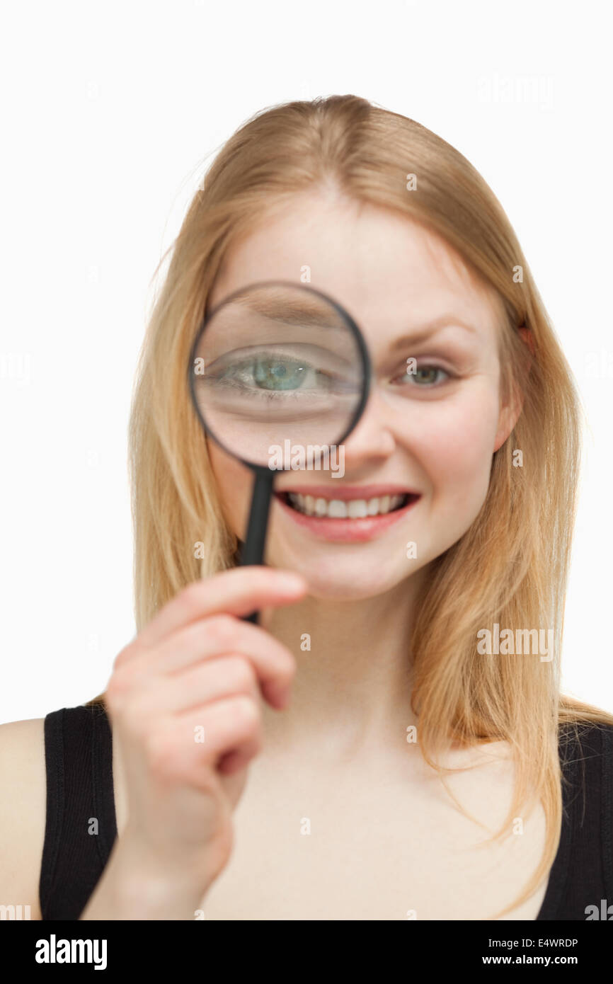 Joyful woman using a magnifying glass Stock Photo Alamy