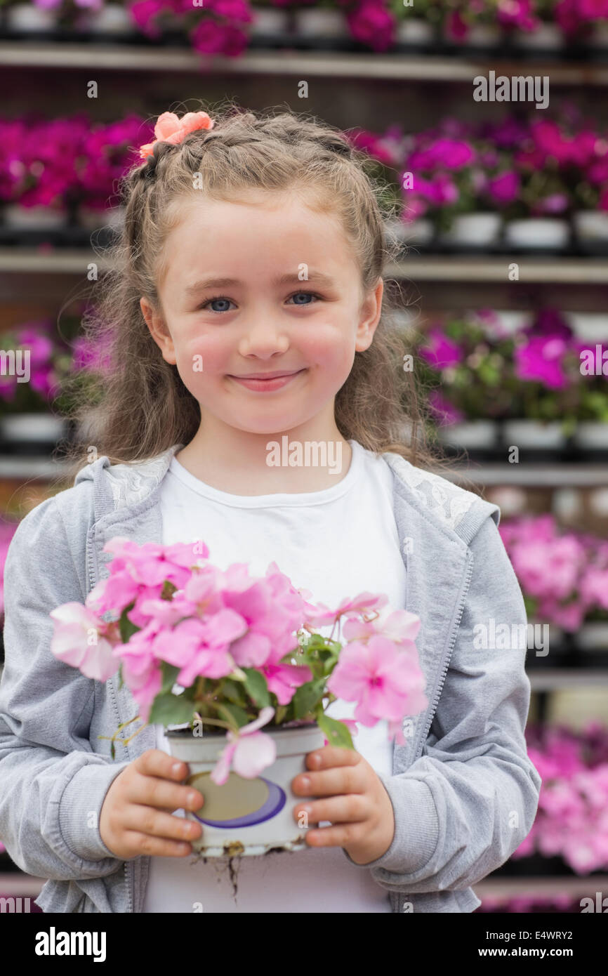 Little girl holding a plant Stock Photo