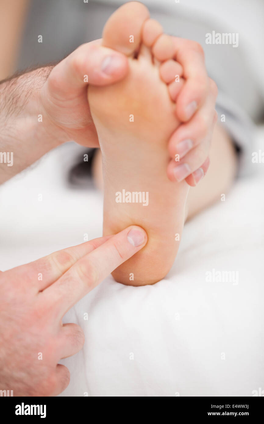Doctor massaging the ball of the foot Stock Photo Alamy