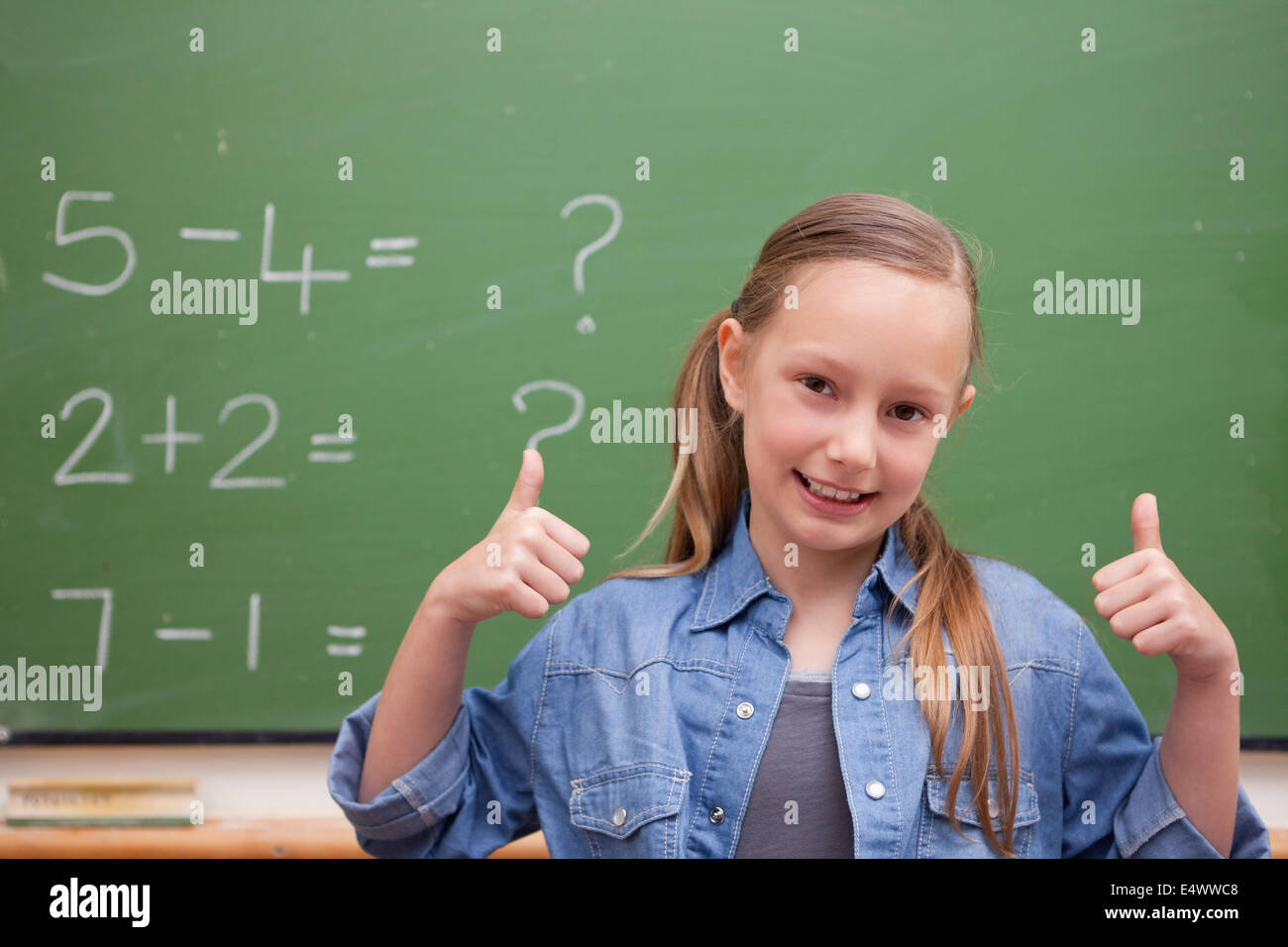 Smiling schoolgirl with the thumbs up Stock Photo - Alamy