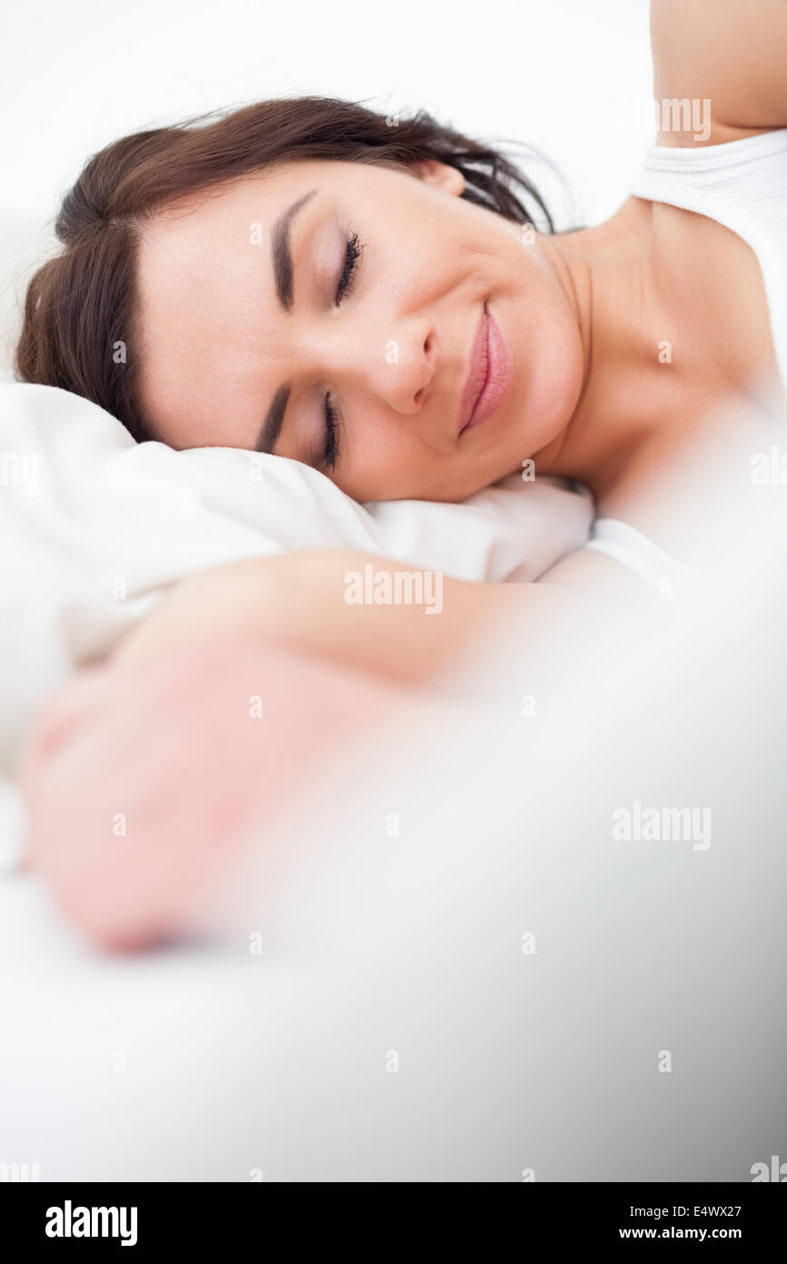 Brunette woman closing her eyes while lying Stock Photo - Alamy