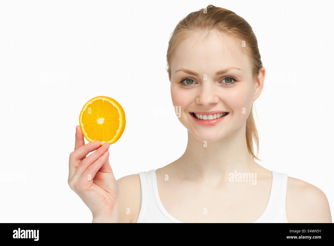 Cheerful woman presenting orange hi-res stock photography and images ...