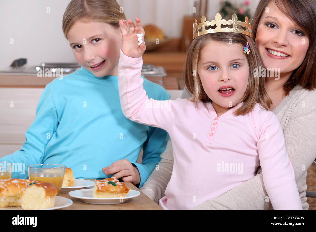 Woman and little girls celebrating Epiphany Stock Photo