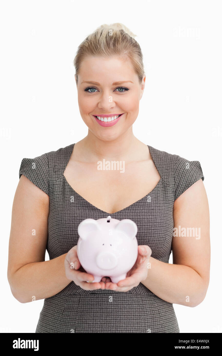 Woman showing a pink piggy bank Stock Photo - Alamy