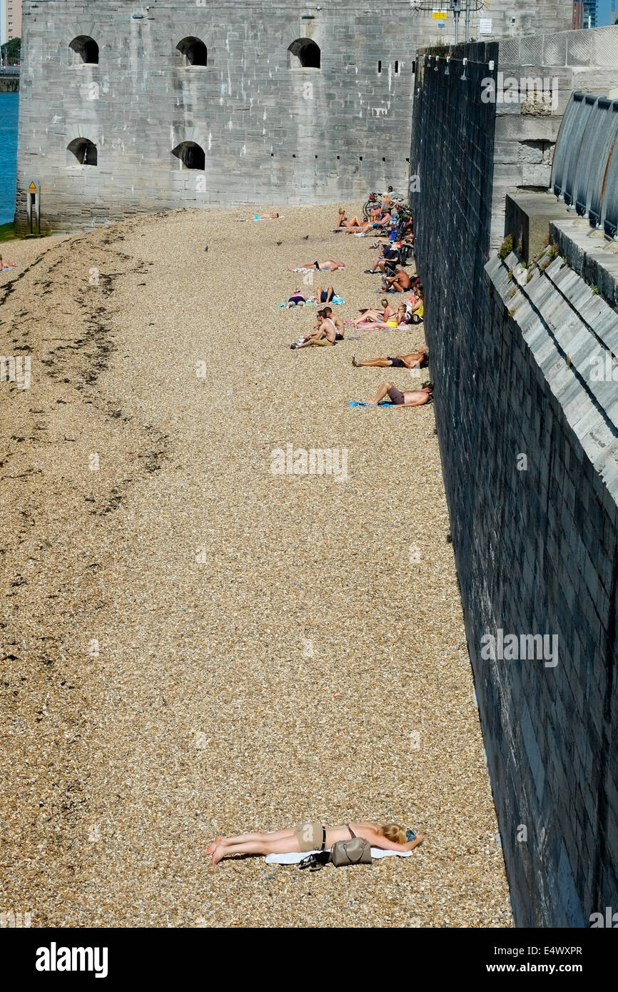 sunbathers on the beach at the hot walls on a hot sunny day between old portsmouth and southsea uk Stock Photo