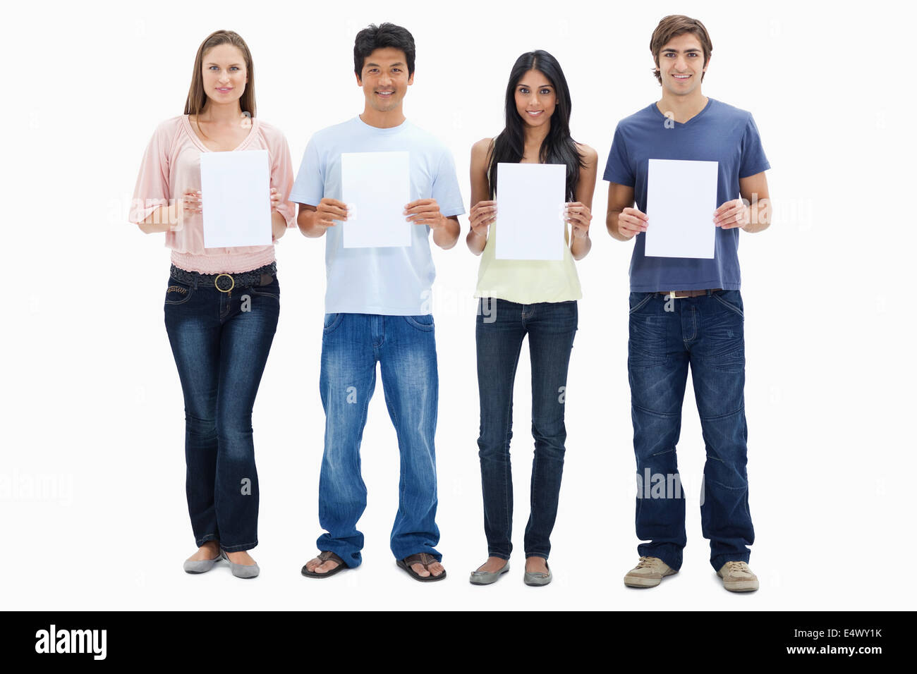 Four people in jeans holding signs Stock Photo
