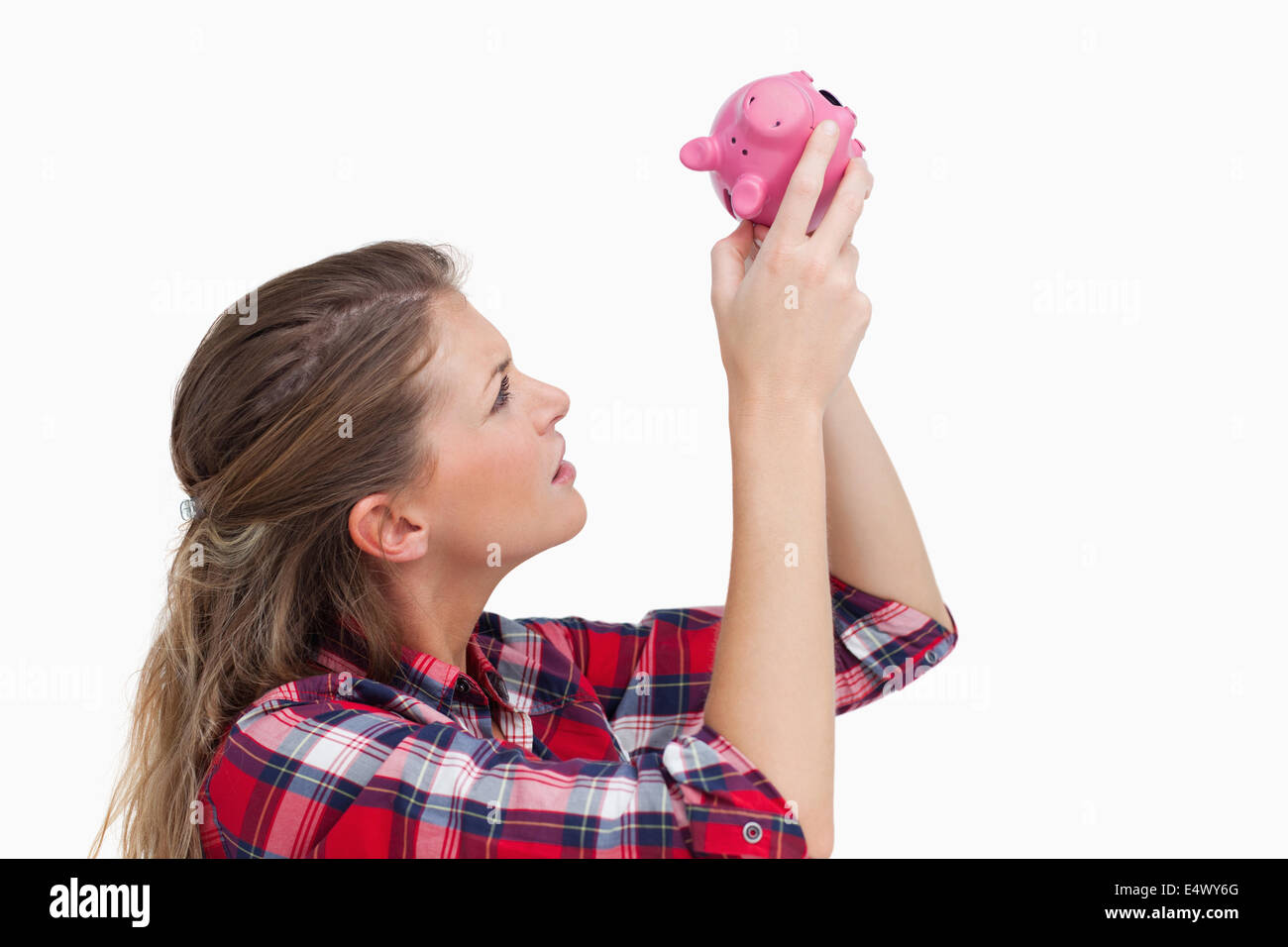 Woman looking inside a piggy bank Stock Photo - Alamy