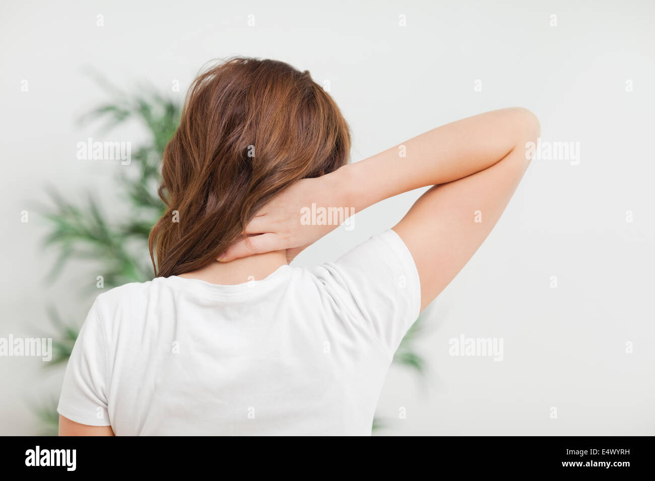 Woman massaging her neck Stock Photo - Alamy