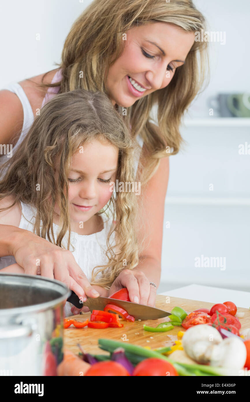 Daughter learning how to cut vegetables Stock Photo Alamy