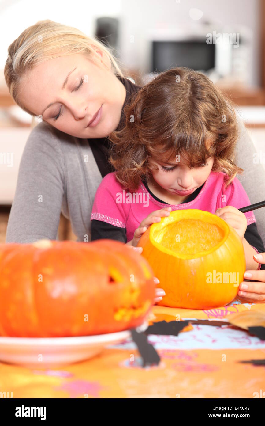 Woman and girl with pumpkins Stock Photo