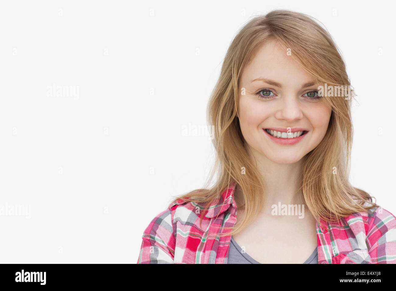 Blonde woman looking at camera while smiling Stock Photo - Alamy
