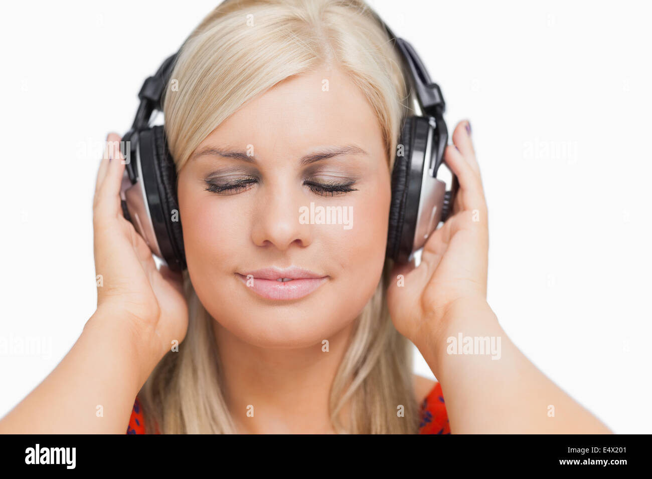 Blonde in dress listening to music Stock Photo - Alamy
