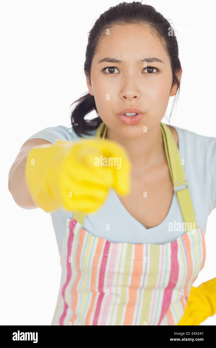 Accusing woman in apron pointing Stock Photo
