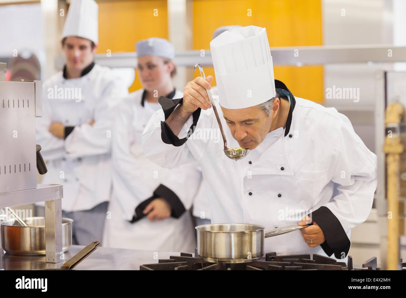 Chef tasting his students work Stock Photo