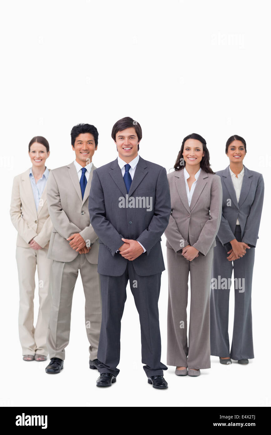 Smiling businessman standing with his team Stock Photo - Alamy