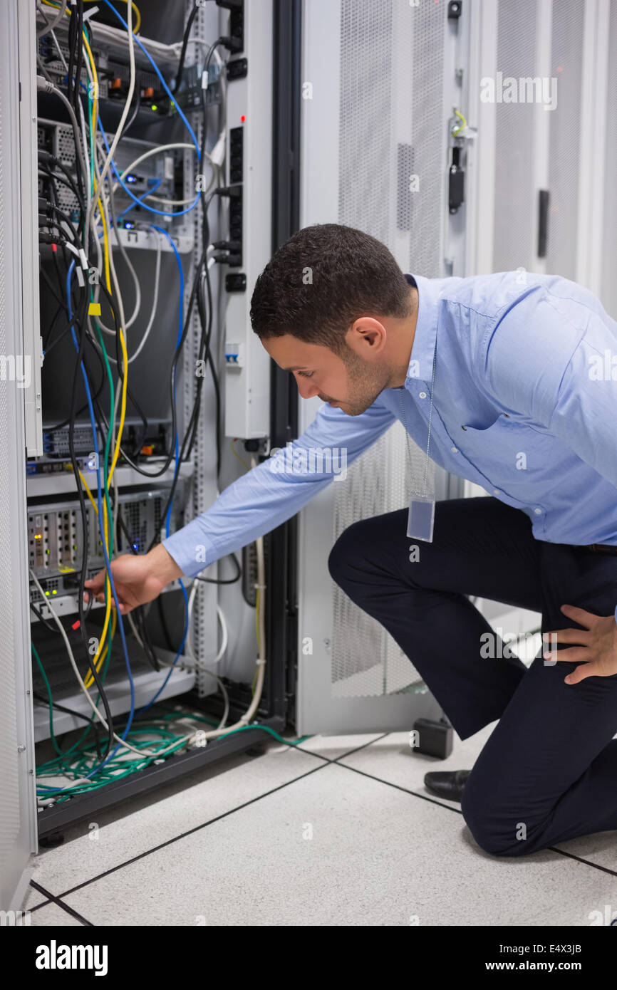 Man plugging a cable into server Stock Photo Alamy