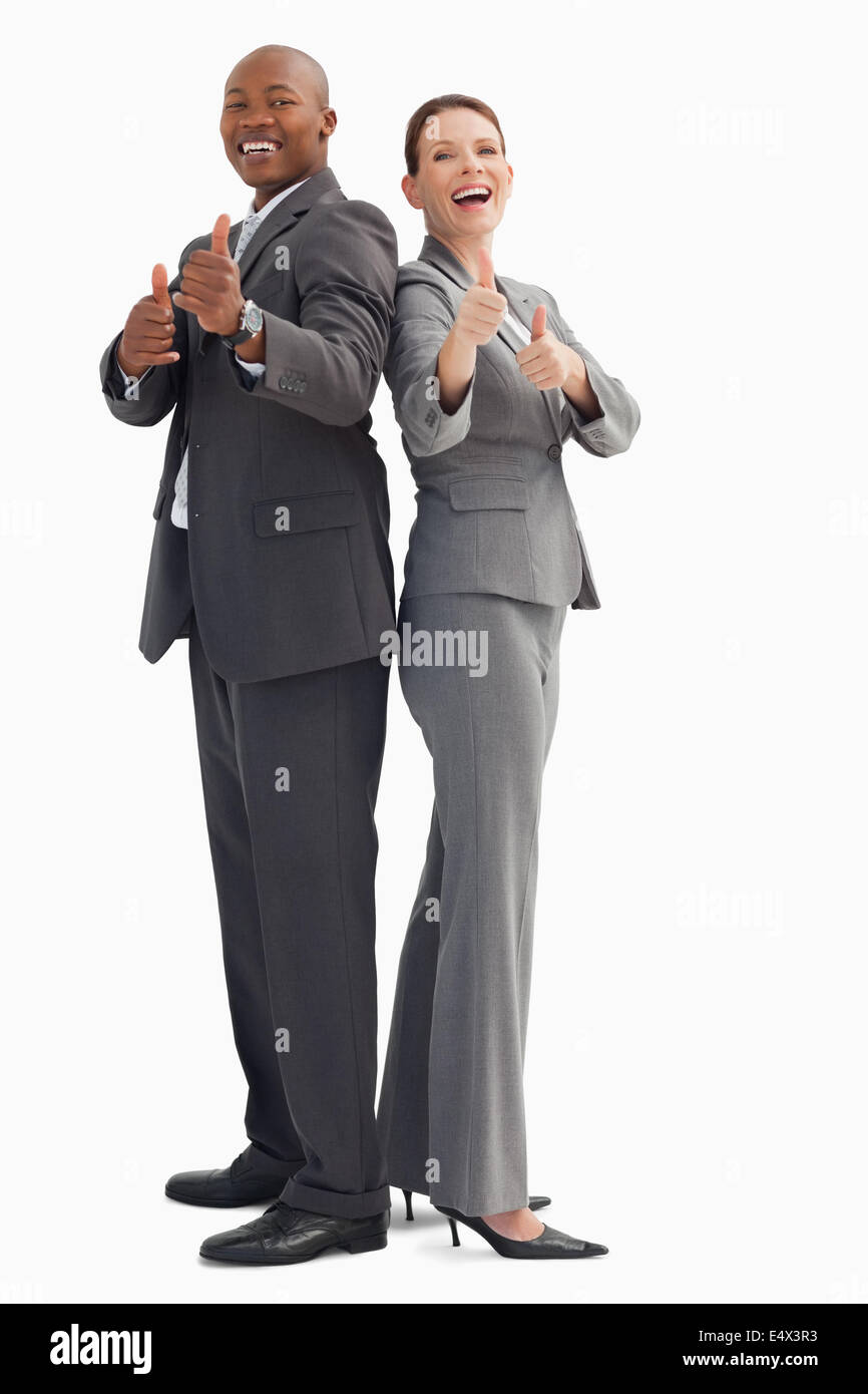 Smiling business people with thumbs up Stock Photo - Alamy