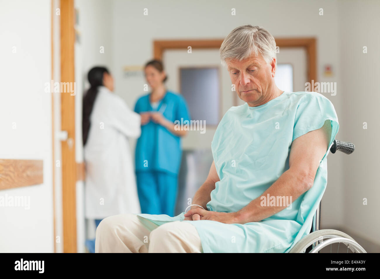 Patient in a wheelchair looking down Stock Photo Alamy