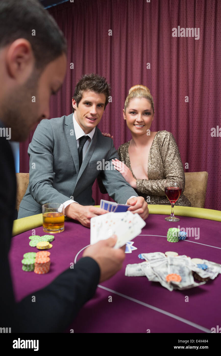 Happy couple playing poker Stock Photo