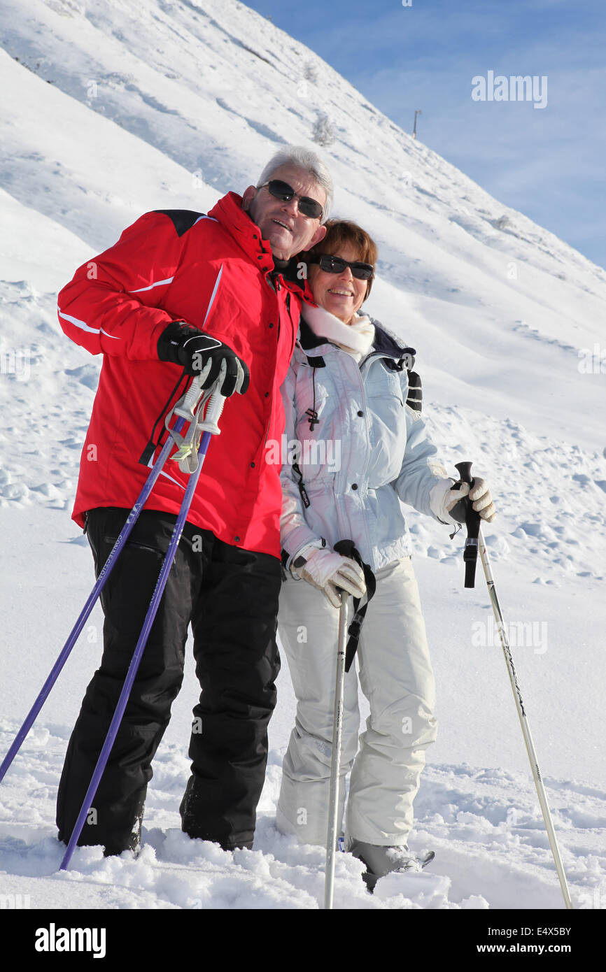 Senior couple walking in the snow Stock Photo