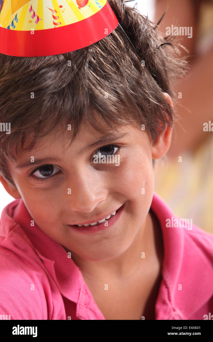 Little boy wearing a birthday party hat Stock Photo
